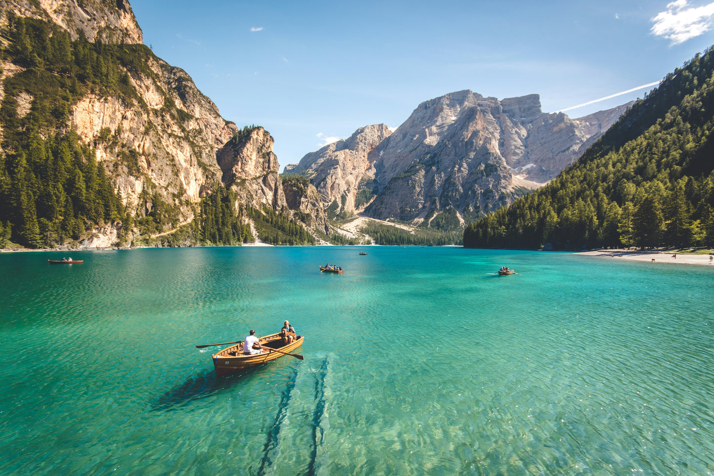 Poster: three brown wooden boat on blue lake water taken at daytime – Pietro De Grandi (Unsplash)