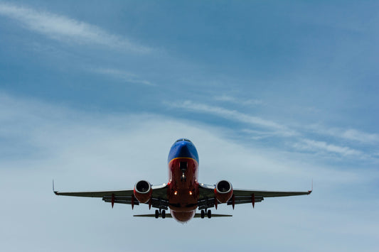 Stretched Canvas: blue and red airplane on sky – Gary Lopater (Unsplash)