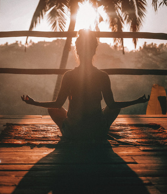 Stretched Canvas: woman doing yoga meditation on brown parquet flooring – Jared Rice (Unsplash)