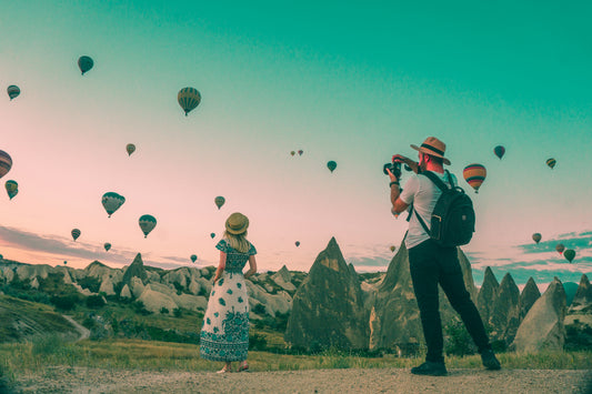 Stretched Canvas: man taking photo of hot air balloons – Mesut Kaya (Unsplash)