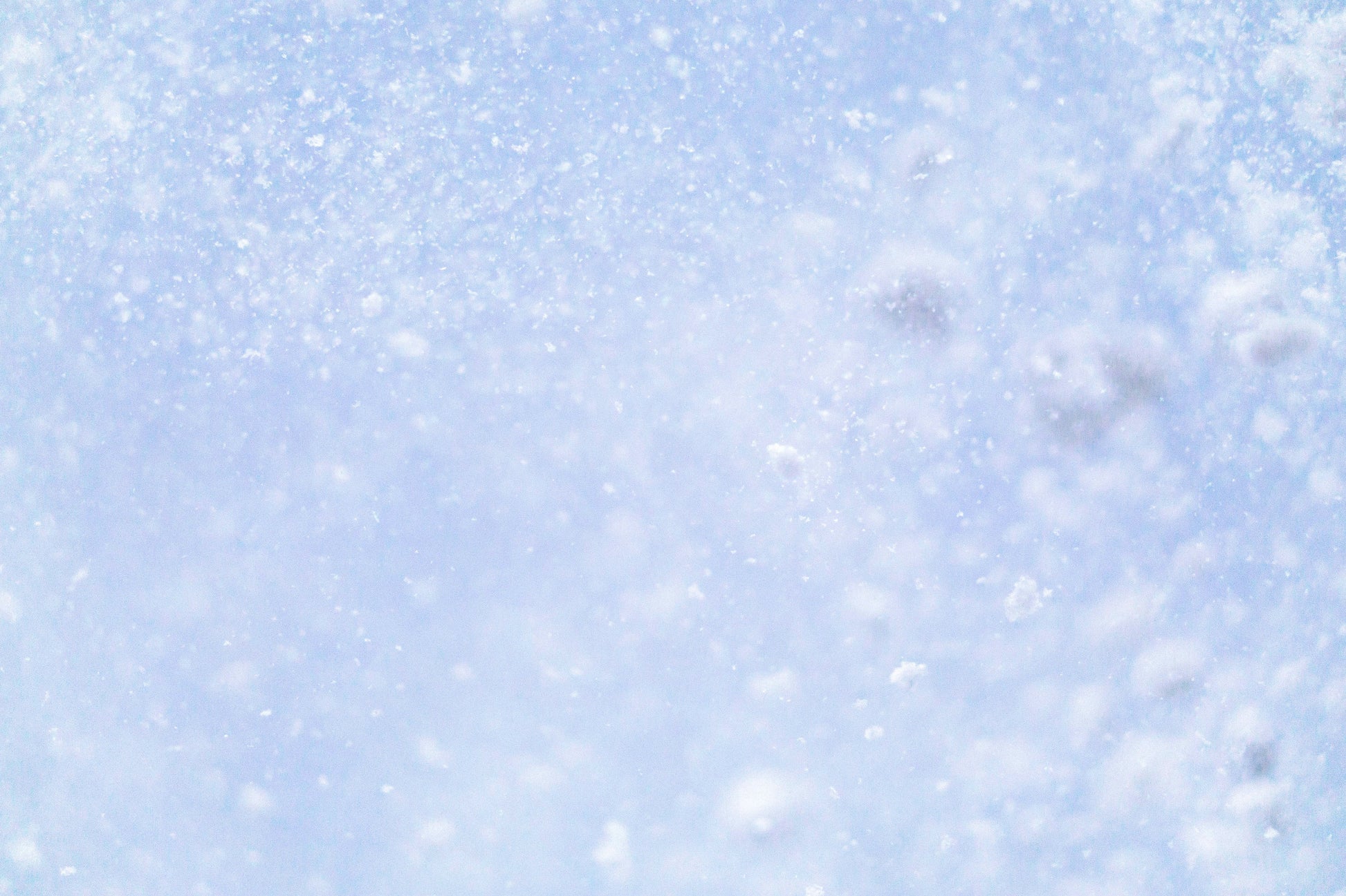 Stretched Canvas: a close up of a snow flakes on a blue sky – geissht (Unsplash)