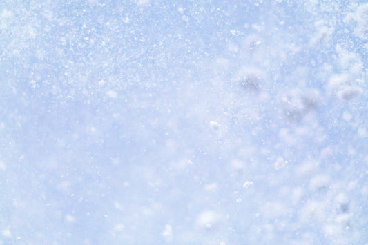 Stretched Canvas: a close up of a snow flakes on a blue sky – geissht (Unsplash)