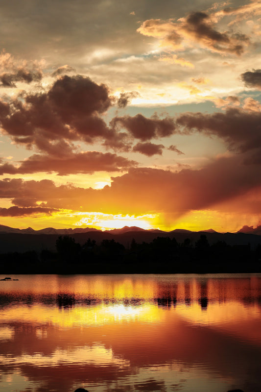 Stretched Canvas: silhouette of mountain and trees near lake under orange sky and clouds – Mia Anderson (Unsplash)