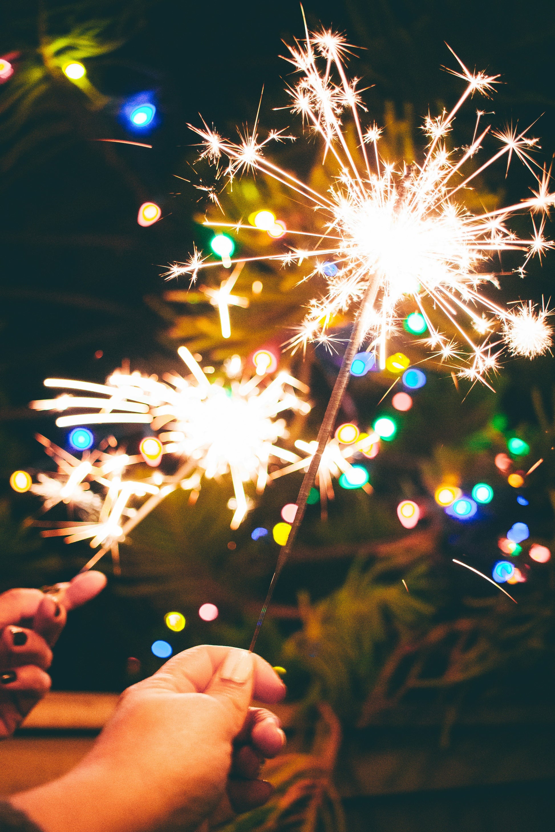 Stretched Canvas: a person is holding a sparkler in their hand – Marisol Benitez (Unsplash)