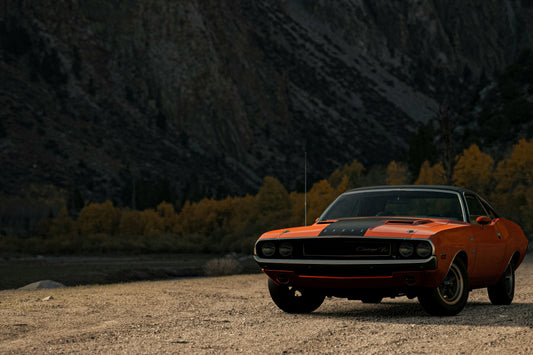 Poster: orange chevrolet camaro on dirt road during daytime – Alexandros Athanasopoulos (Unsplash)
