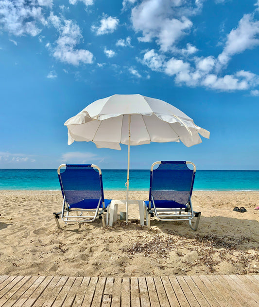 Stretched Canvas: blue and white chair under white umbrella on beach during daytime – Marko Kelecevic (Unsplash)